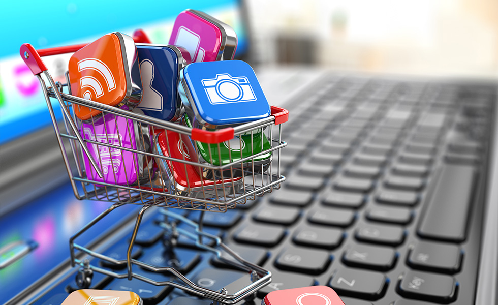 Store of laptop software. Apps icons in shopping cart.